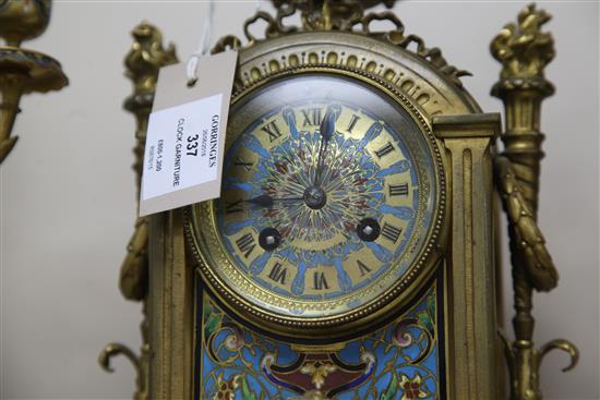 A third quarter of the 19th century French champlevé enamel and ormolu clock garniture, height clock 14in. candelabra 14.75in.